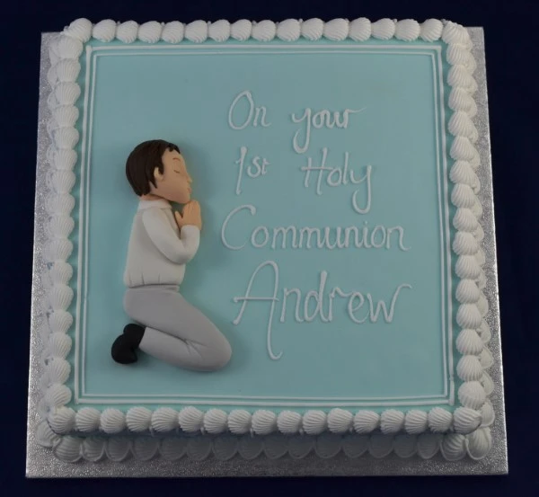 Bespoke Communion cake for boy and girl with white icing and delicate cross decorations in Solihull, West Midlands.