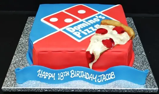 Bespoke cake shaped like a Domino's pizza box with a slice, crafted for celebration in Solihull, West Midlands.