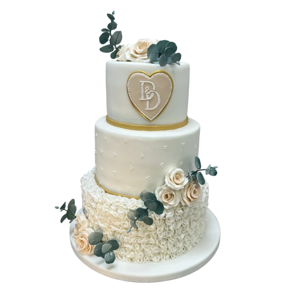 Three-tiered wedding cake with sugar paste, roses, eucalyptus, and gold accents.