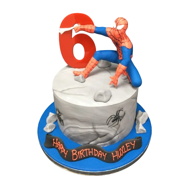 Bespoke crouching Spiderman cake with detailed webbing and vibrant colors, made in Solihull, West Midlands.