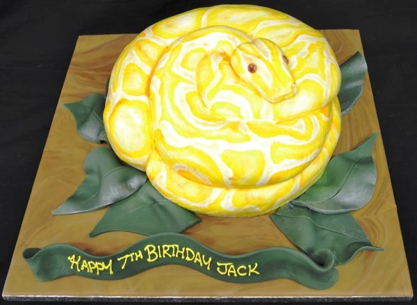 Bespoke Python-themed celebration cake with realistic snake design, detailed scales, and vibrant colors in Solihull, West Midlands.