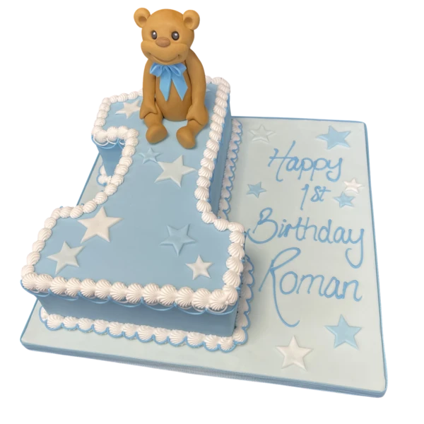 Adorable teddy bear cake topper on a number 1 shaped cake for a first birthday celebration, perfect for a special occasion in UK.