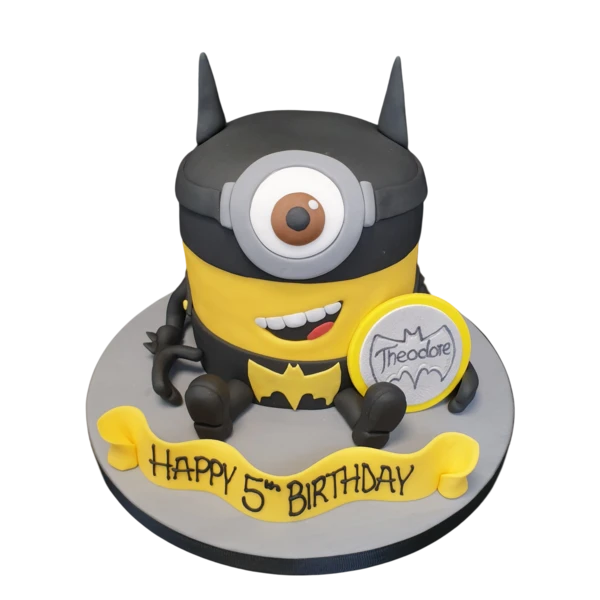 A fun and quirky Batman Minion-themed cake featuring a popular animated character wearing Batman's iconic costume, perfect for themed parties and celebrations.