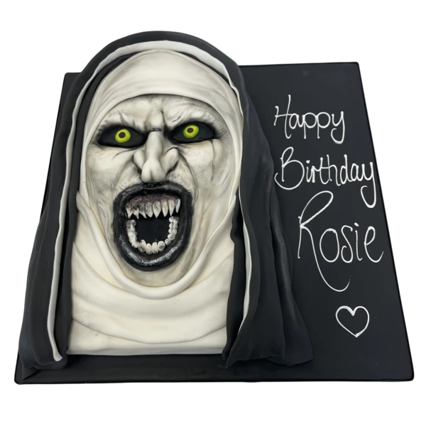 Bespoke cake shaped like a nun in traditional habit, crafted for celebration in Solihull, West Midlands.