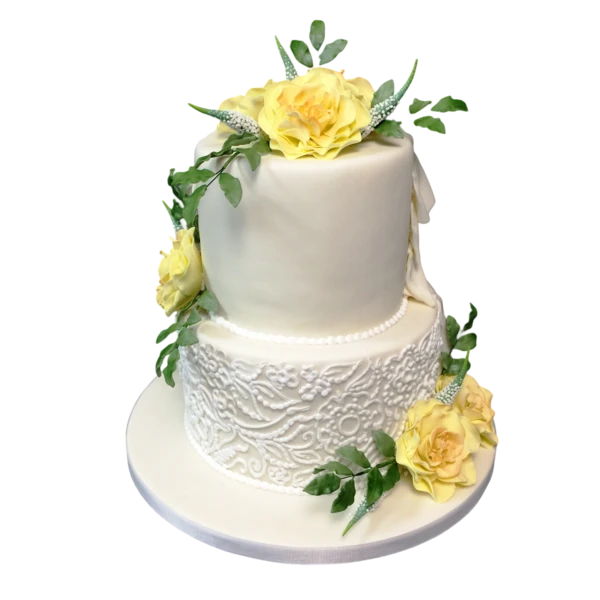Two-tier wedding cake with yellow roses, sugar paste, and lace texture detailing.