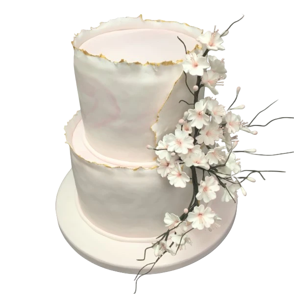 Two-tier wedding cake with sugar paste, gold accents, and delicate sugar blossoms.