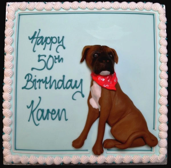 Bespoke celebration cake in Solihull, West Midlands featuring a detailed boxer dog figure on a square base.