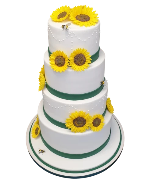 Four-tier white wedding cake with sunflowers, green ribbons, and sugar paste bees.