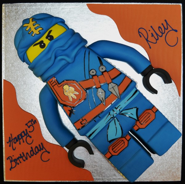 Bespoke Ninjago Lego man cake with vibrant colors and detailed character design in Solihull, West Midlands.