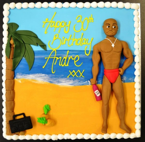 Bespoke "Hunk on the Beach" celebration cake with a muscular figure and beach theme in Solihull, West Midlands.