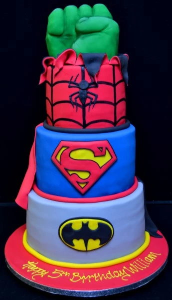 Bespoke superhero trio cake with Hulk fist decoration for celebration in Solihull, West Midlands.