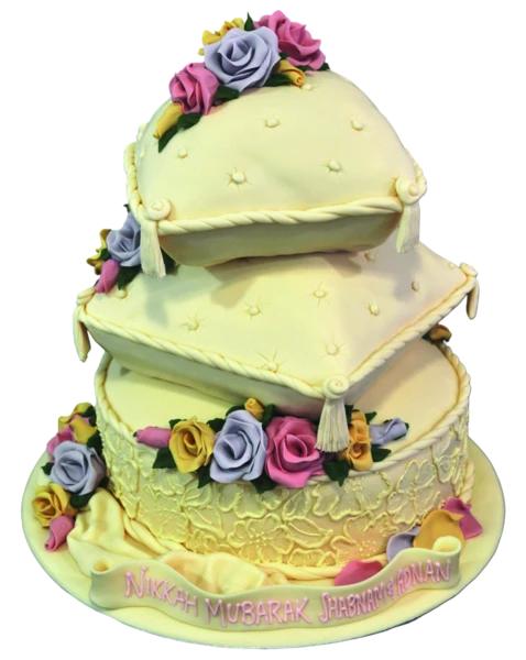 Three-tier wedding cake with pillow design and colourful sugar roses.