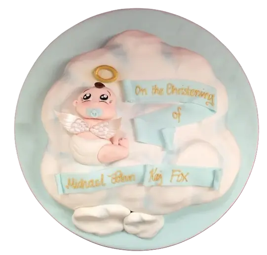 Bespoke celebration cake in Solihull, West Midlands featuring a white cloud base with a detailed cherub figure on top.