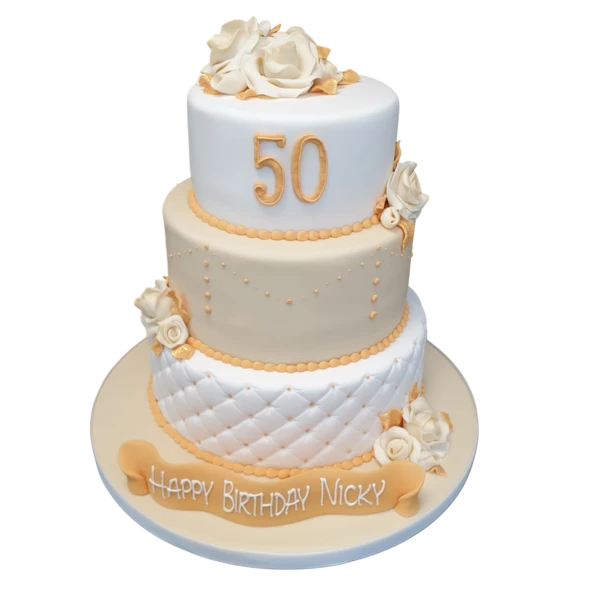 A decadent and elegant 50th birthday cake decorated with gold-flecked frosting and topped with a decorative number fifty candle and glittering sprinkles.
