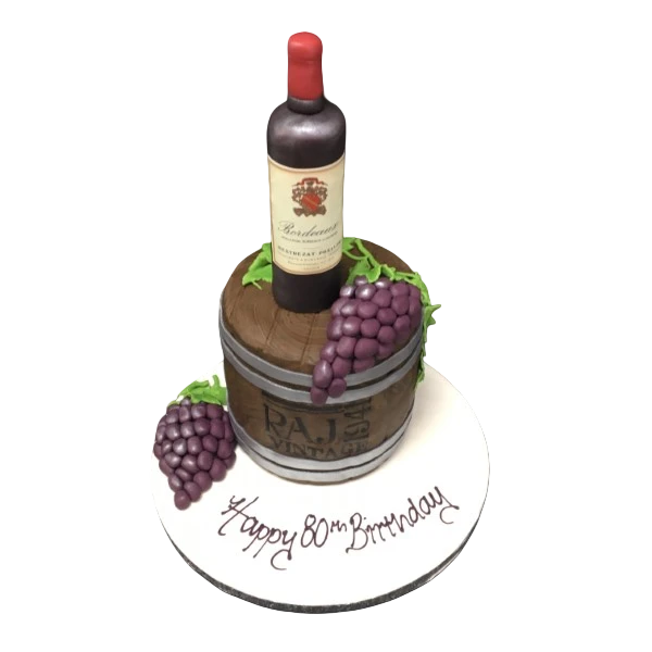 Luxurious wine bottle-shaped cake on a rustic wooden cask surrounded by realistic sugarcrafted grapes, perfect for wine lovers' celebrations.