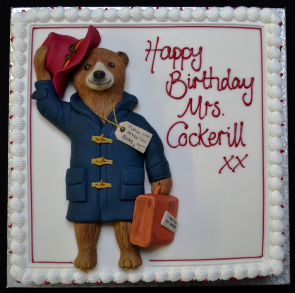 A charming and intricately designed Paddington Bear themed cake with exquisite detailing, perfect for a special celebration or occasion.