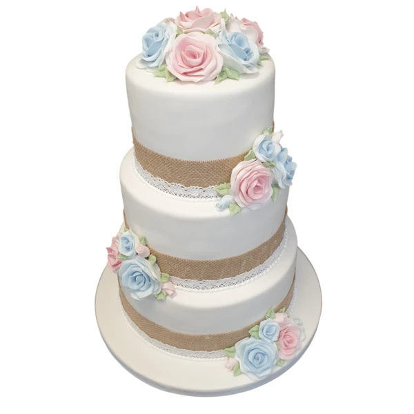 Three-tier wedding cake with sugar paste roses, burlap, and lace trim accents.