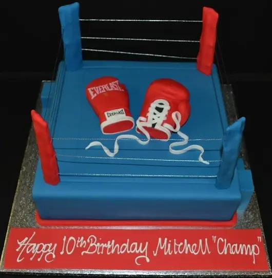 Bespoke boxing ring cake with detailed ropes and corner posts, crafted for a celebration in Solihull, West Midlands.