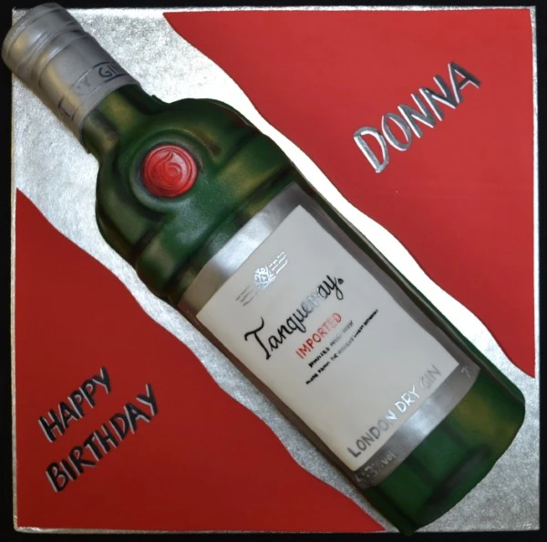 Bespoke celebration cake shaped like a Tanqueray Gin bottle with detailed label, crafted in Solihull, West Midlands.