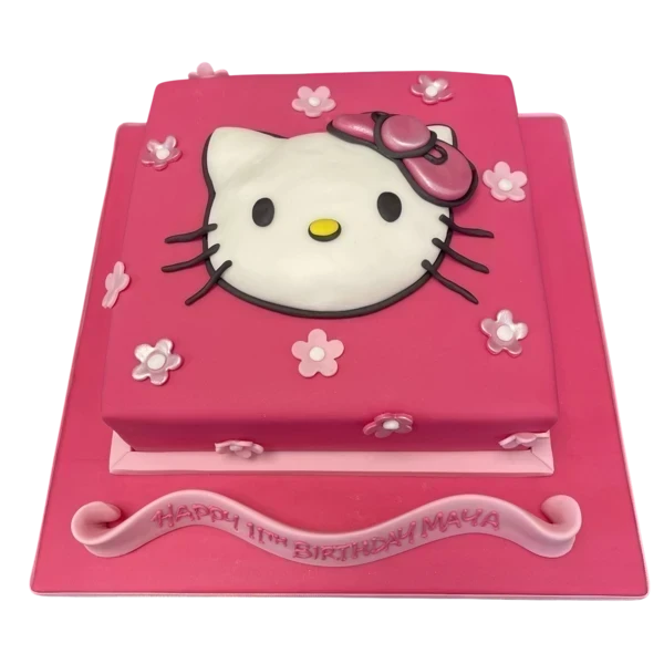 A cute and whimsical Hello Kitty themed cake with pink icing, bows, and a cute character sculpture on top, perfect for any fans of the popular Japanese character.