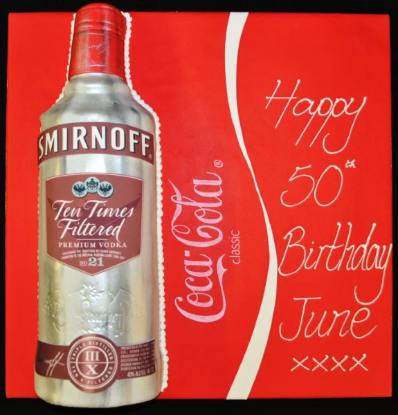 Bespoke cake shaped like a Smirnoff vodka bottle with detailed label design, made in Solihull, West Midlands.