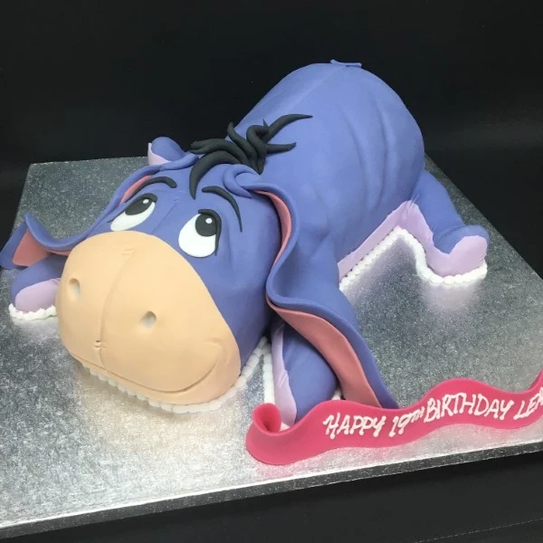 Adorable Eeyore-themed cake featuring the beloved Pooh's friend, perfect for a whimsical celebration or party in UK. Ideal for fans of the classic story.
