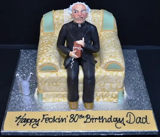 Bespoke cake of a crazed vicar in an armchair with detailed facial features, Solihull, West Midlands.