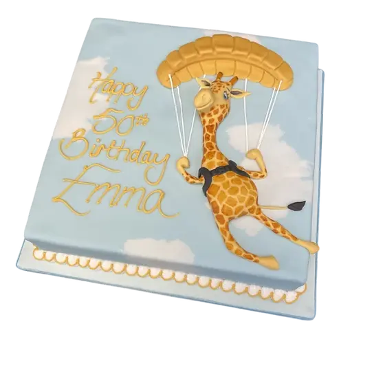 Bespoke cake featuring a giraffe parachuting with a colorful parachute, crafted in Solihull, West Midlands.
