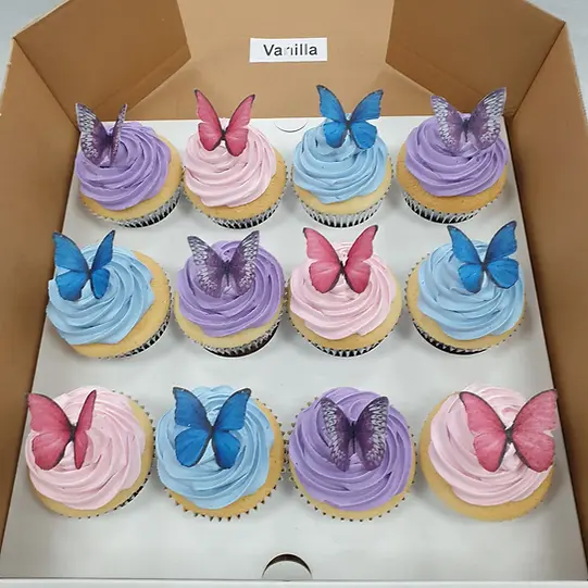 Bespoke butterfly cupcakes with pastel icing and delicate sugar wings, perfect for celebration in Solihull, West Midlands.
