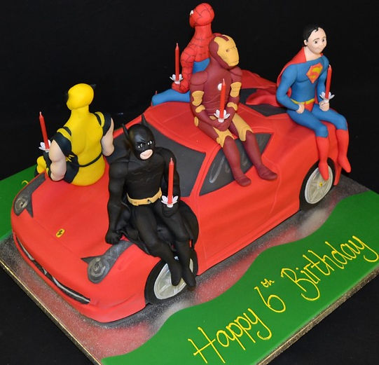 Bespoke superhero Ferrari-themed cake with vibrant red and yellow icing, displayed in Solihull, West Midlands.