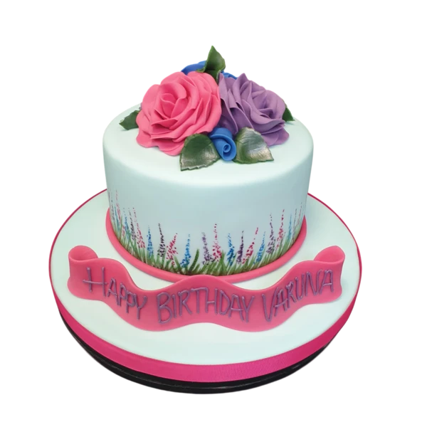 A vibrant and beautifully decorated cake featuring a stunning arrangement of colourful roses on top. Perfect for special occasions and celebrations.