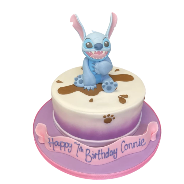 Whimsical and fun Stitch character cake in blue and purple colours, perfect for birthdays and themed parties. Hand-crafted cake design for Disney fans.