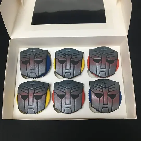 Bespoke Transformers-themed cake with detailed robot figures and vibrant colors, crafted in Solihull, West Midlands.