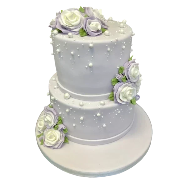Two-tier wedding cake with lavender and white sugar paste roses and pearls.