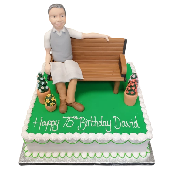 Beautifully designed cake featuring a man sitting on a garden bench, perfect for special occasions and celebrations in UK.