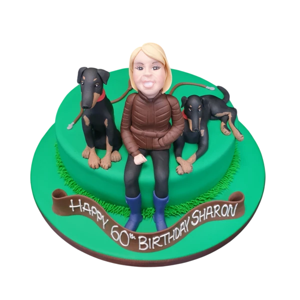 An intricately designed birthday cake featuring a lady with dogs as a decorative theme, perfect for dog lovers and special occasions.