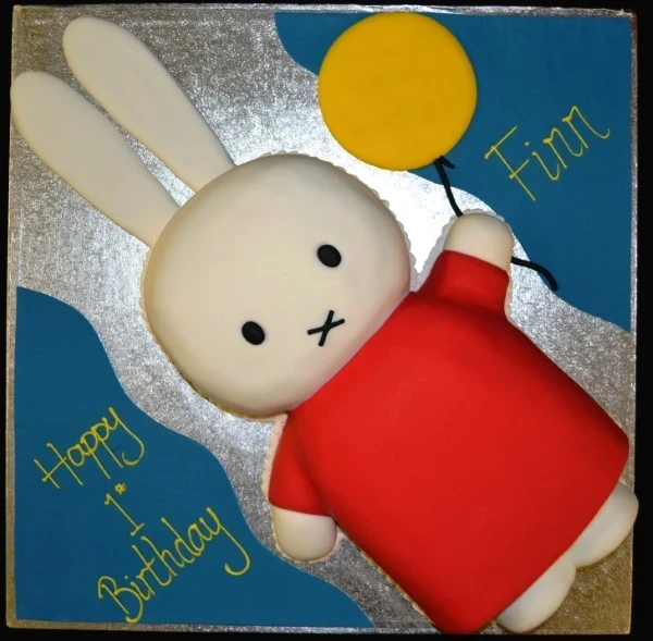 Bespoke full-body Miffy cake with smooth white icing and orange dress, crafted for celebration in Solihull, West Midlands.