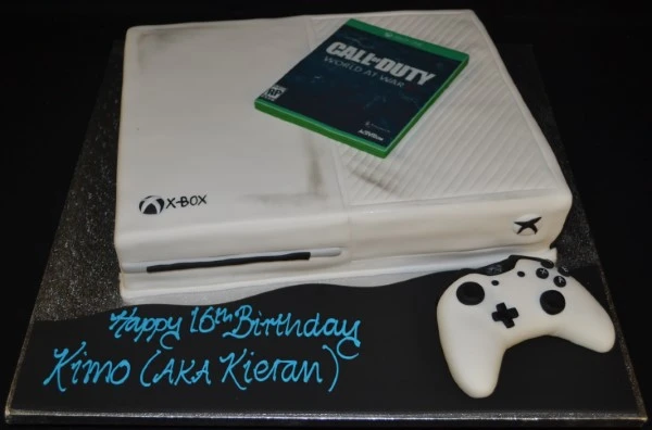 Bespoke Xbox-themed cake with green and black fondant, controller details, in Solihull, West Midlands celebration.