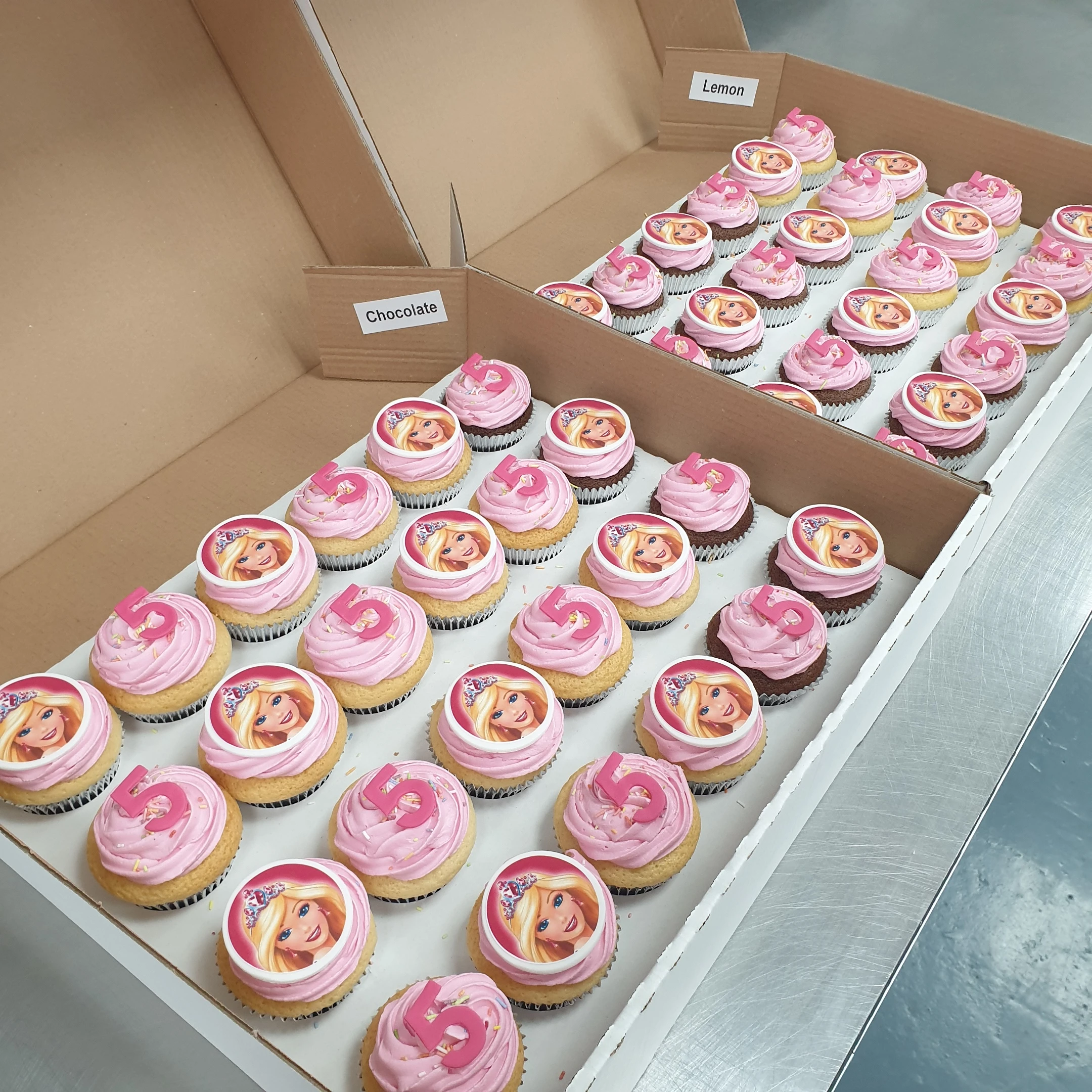 Beautifully decorated Barbie cupcakes on a cake stand.