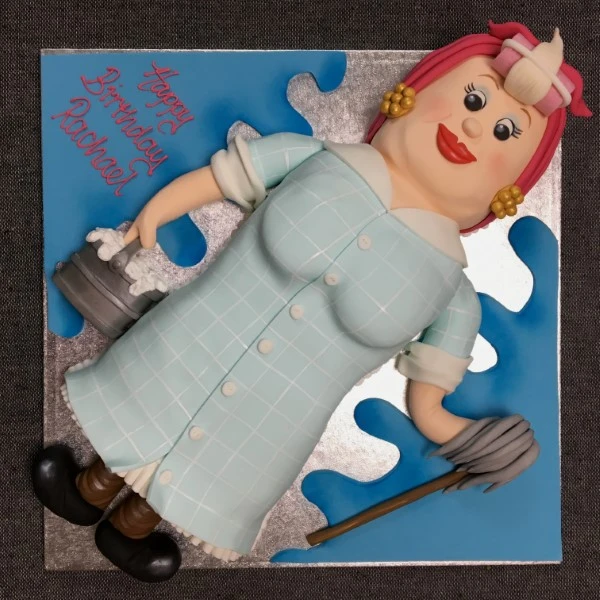 Bespoke cake shaped like a mop lady with detailed hair and outfit, perfect for celebration in Solihull, West Midlands.
