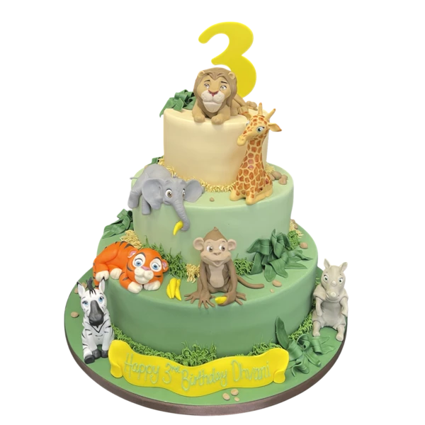 Bespoke celebration cake featuring detailed safari animal figures, lush greenery, and vibrant decorations in Solihull, West Midlands.