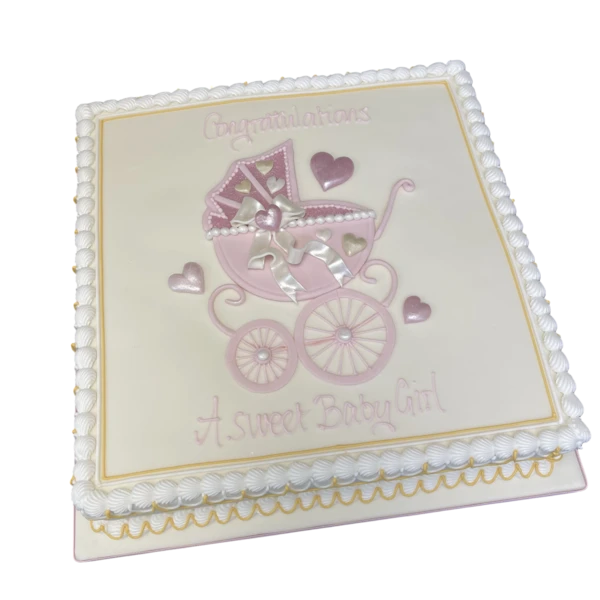 Beautifully decorated baby shower cake in pink and white with a miniature pram topper for a baby girl celebration.