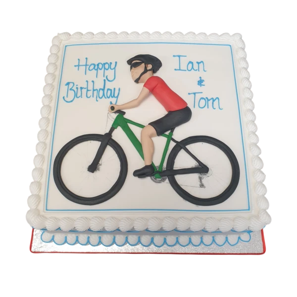 Bespoke cake in Solihull, West Midlands featuring a cyclist riding a detailed bike on a scenic trail for celebration.