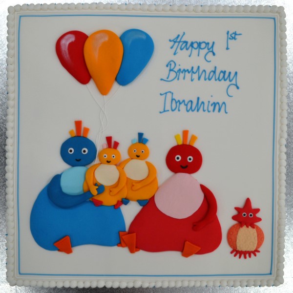 A whimsical and brightly colored Twirlywoos-themed cake decorated with fondant characters on top, perfect for a fun-filled celebration.