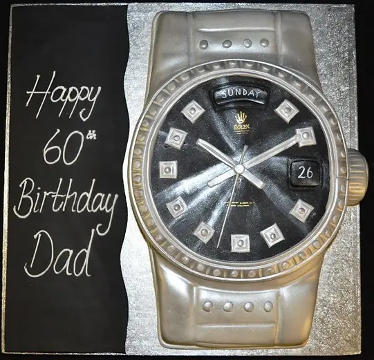 Bespoke cake shaped like a Rolex watch with detailed silver and black design, crafted in Solihull, West Midlands.