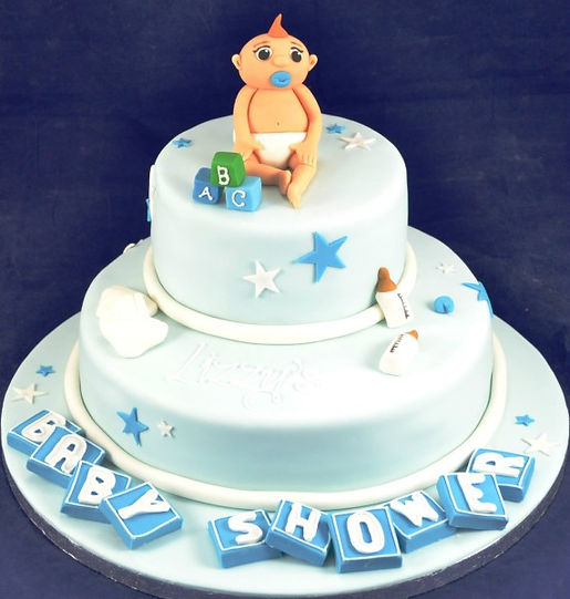 Bespoke baby shower celebration cake with pastel blue and pink fondant, decorated with tiny booties in Solihull, West Midlands.