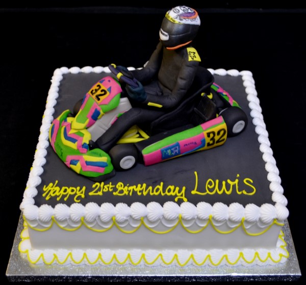A beautifully decorated go-kart themed cake, perfect for a racing enthusiast's birthday celebration. Ideal for fans of motorsports and fast-paced fun.