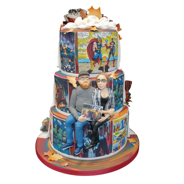 Three-tiered wedding cake with comic designs and personalised couple figures.