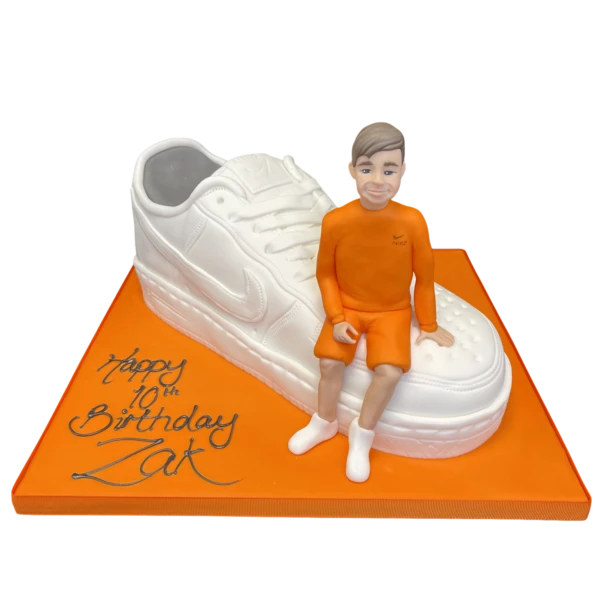 Bespoke celebration cake in Solihull, West Midlands, featuring a detailed boy figurine on a trainer bike.