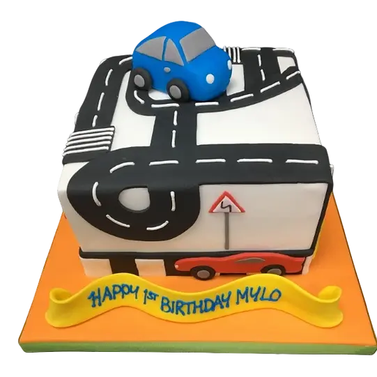 Bespoke celebration cake in Solihull, West Midlands featuring a road design with colorful cars on top.